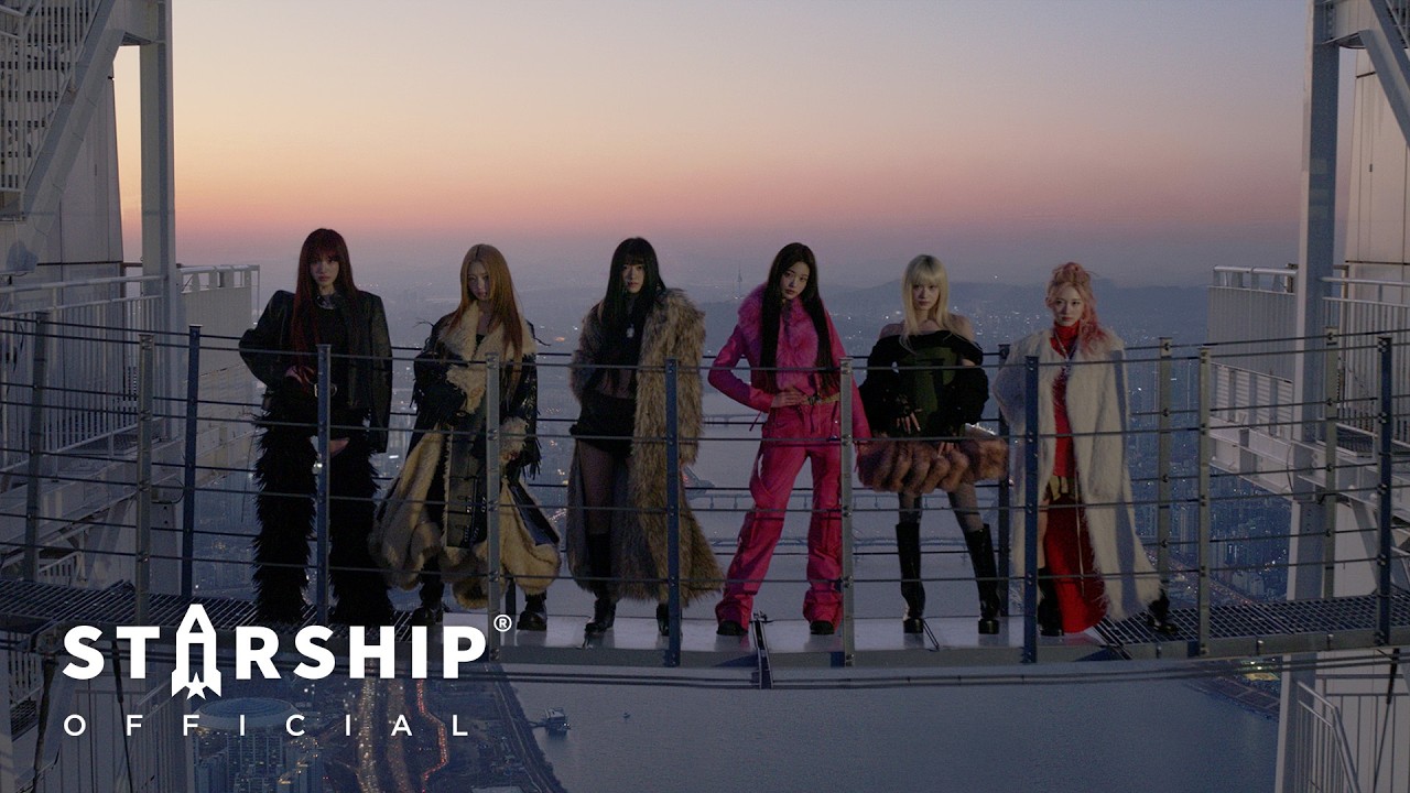 IVE members standing on a rooftop at dusk in the Blackhole music video, with a city skyline behind them.